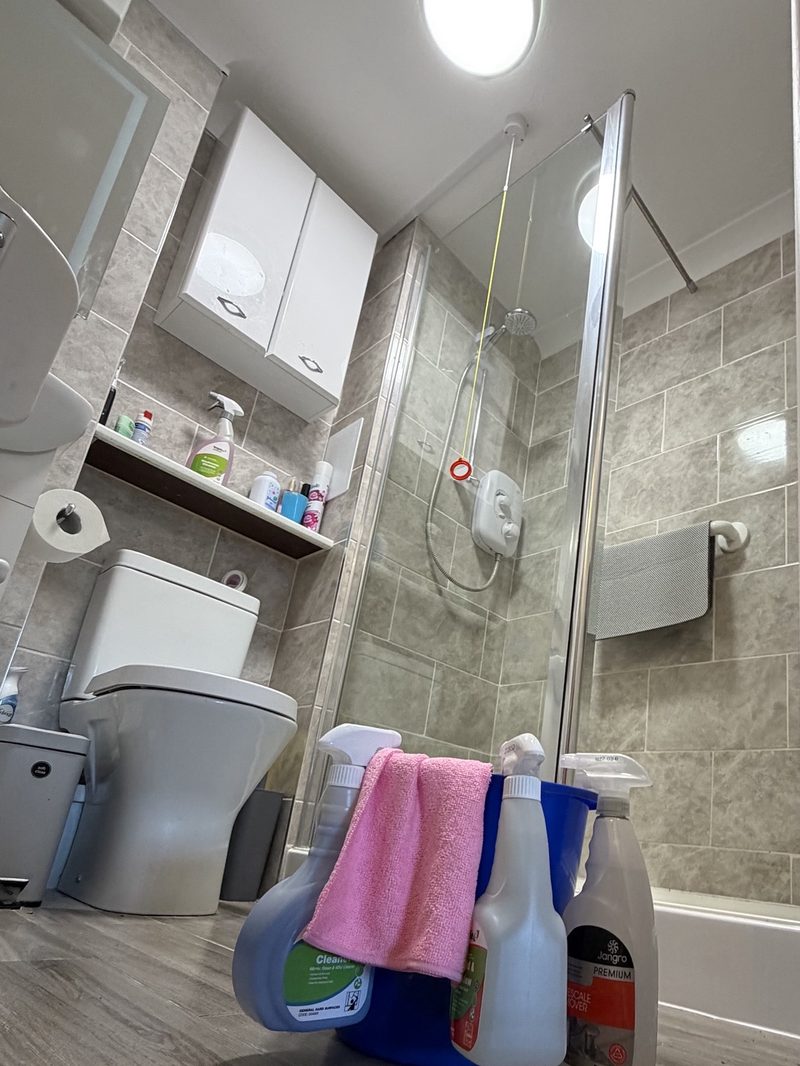 Cleaning products and cloths set out ready in a bathroom